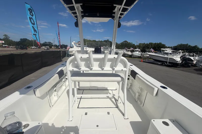 Slide: The Image of 2020 Clearwater 2000 Center Console boat interior at dealership, showcasing seating and rod holders. - 20