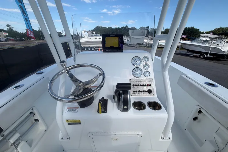 Slide: The Image of 2020 Clearwater 2000 Center Console boat dashboard with steering wheel and gauges. - 32