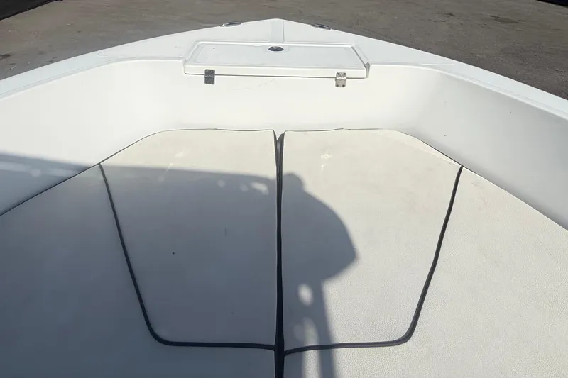 Slide: The Image of 2020 Clearwater 2000 Center Console boat interior with cushioned seating and storage compartment. - 52