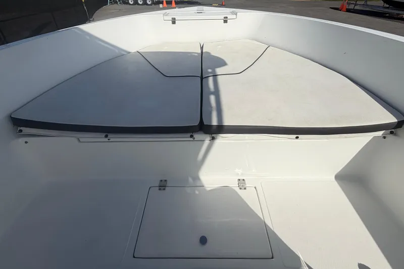 Slide: The Image of 2020 Clearwater 2000 Center Console boat interior with cushioned seating and storage compartment. - 50