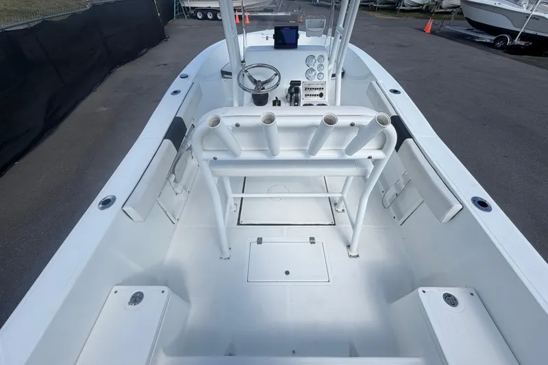 Slide: The Image of 2020 Clearwater 2000 Center Console boat interior with steering wheel and rod holders. - 21