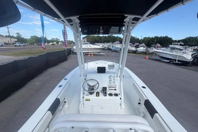 Slide: The Image of 2020 Clearwater 2000 Center Console boat at a dealership, showcasing helm and seating area. - 30