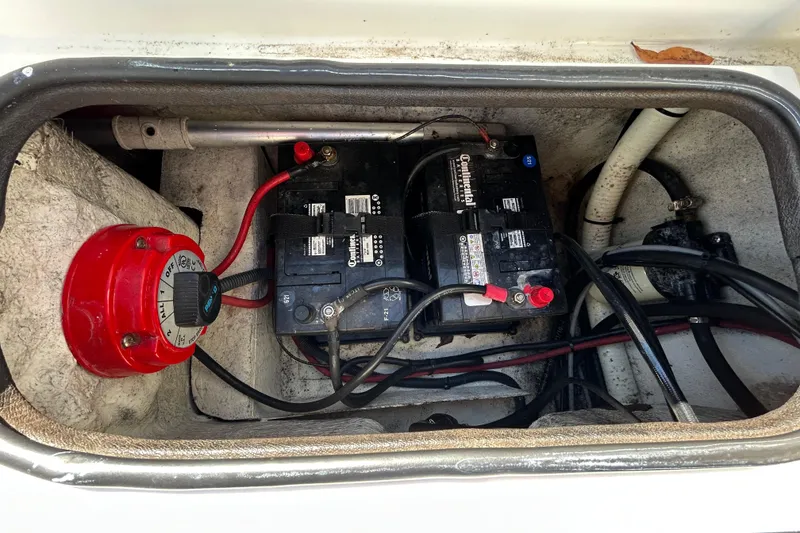 Slide: The Image of Battery compartment of a 2020 Clearwater 2000 Center Console boat, featuring wiring and connections. - 96