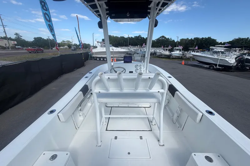 Slide: The Image of 2020 Clearwater 2000 Center Console boat at a dealership, showcasing spacious interior and controls. - 22