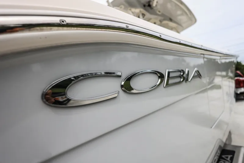 Slide: The Image of 2020 Cobia 301 Center Console boat with chrome logo detail. - 34