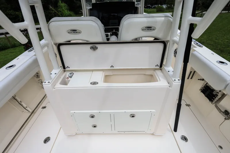 Slide: The Image of 2020 Cobia 301 Center Console boat interior with storage compartment and seating. - 13