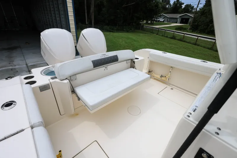 Slide: The Image of 2020 Cobia 301 Center Console boat with dual engines and spacious seating area. - 33