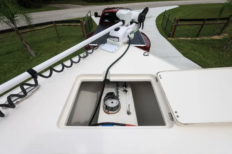 Slide: The Image of 2020 Cobia 301 Center Console boat with open storage compartment and trolling motor. - 23