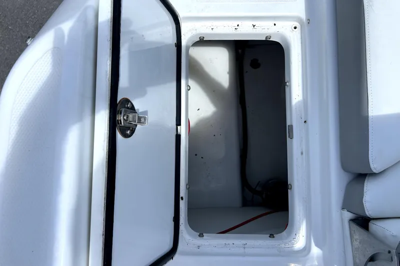Slide: The Image of Open storage compartment on a 2020 Four Winns HD220 boat. - 59