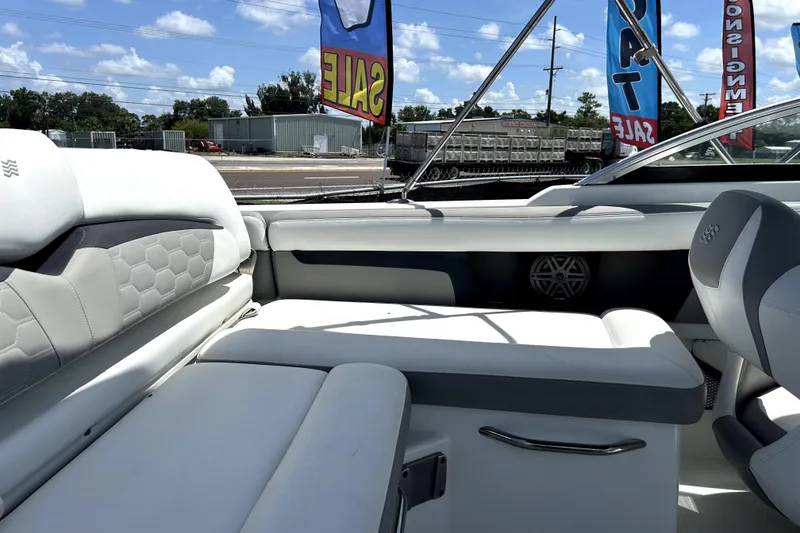 Slide: The Image of 2020 Four Winns HD220 boat interior with white seating and sale banners. - 50