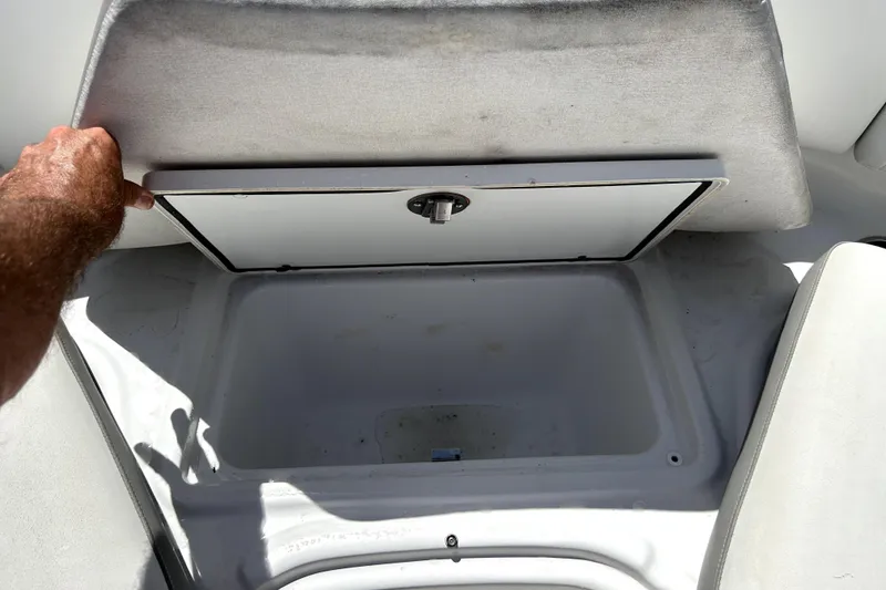 Slide: The Image of Storage compartment in a 2020 Four Winns HD220 boat, open and empty. - 35
