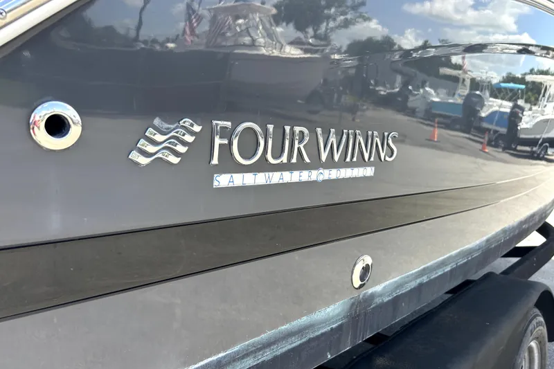 Slide: The Image of 2020 Four Winns HD220 Saltwater Edition boat, close-up of logo and hull. - 65
