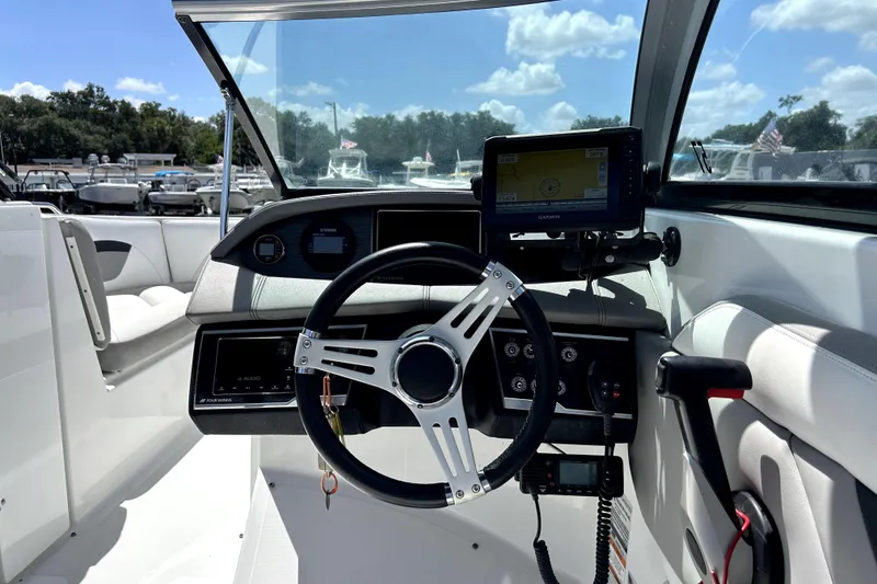 Slide: The Image of 2020 Four Winns HD220 boat cockpit with steering wheel and navigation system. - 18