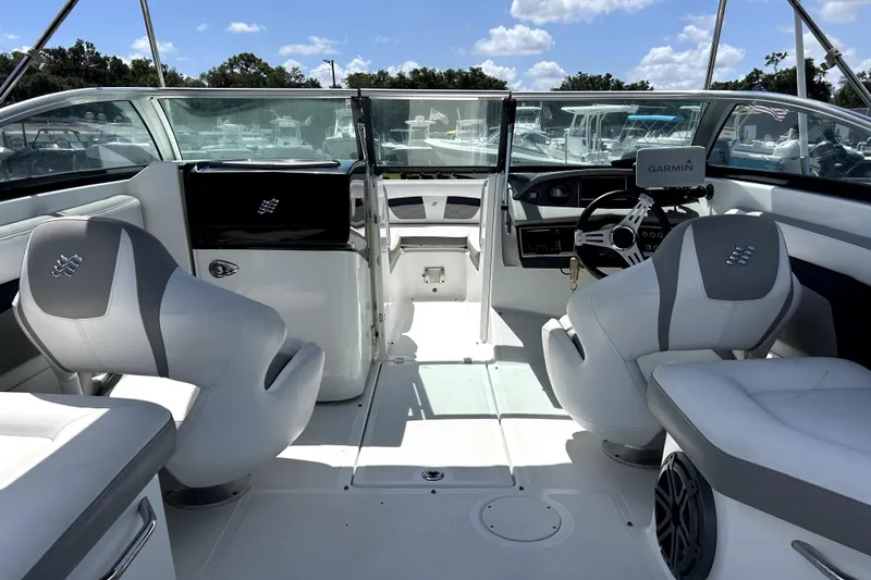Slide: The Image of 2020 Four Winns HD220 boat interior with modern seating and Garmin navigation system. - 16