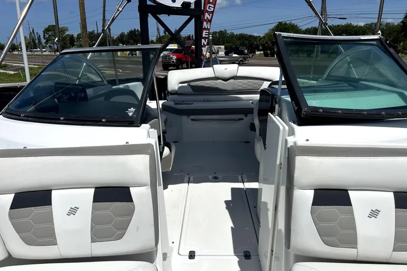 Slide: The Image of 2020 Four Winns HD220 boat interior with white seating and windshield. - 43