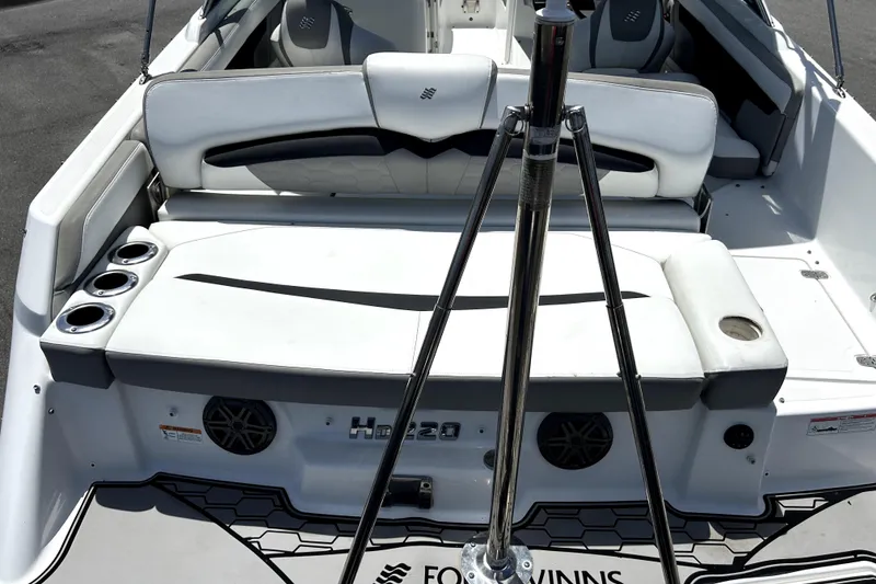Slide: The Image of 2020 Four Winns HD220 boat interior with seating and cup holders. - 61