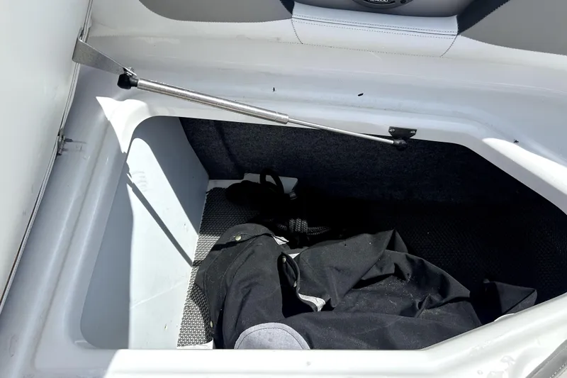 Slide: The Image of Storage compartment of a 2020 Four Winns HD220 boat, featuring interior space and equipment. - 39