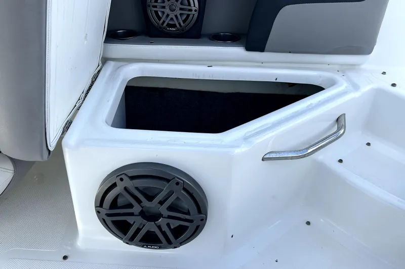 Slide: The Image of 2020 Four Winns HD220 boat storage compartment with speaker and handle. - 55