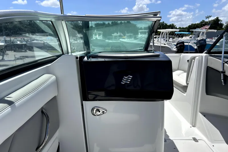 Slide: The Image of 2020 Four Winns HD220 boat interior with sleek design and seating, under a sunny sky. - 30