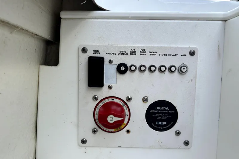 Slide: The Image of Control panel on a 2020 Four Winns HD220 boat, featuring various switches and a digital relay. - 49