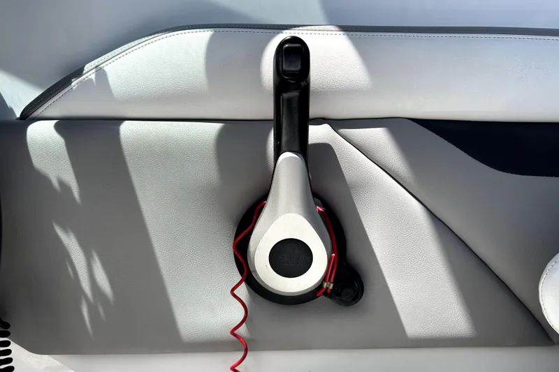 Slide: The Image of Throttle control lever on a 2020 Four Winns HD220 boat interior. - 24