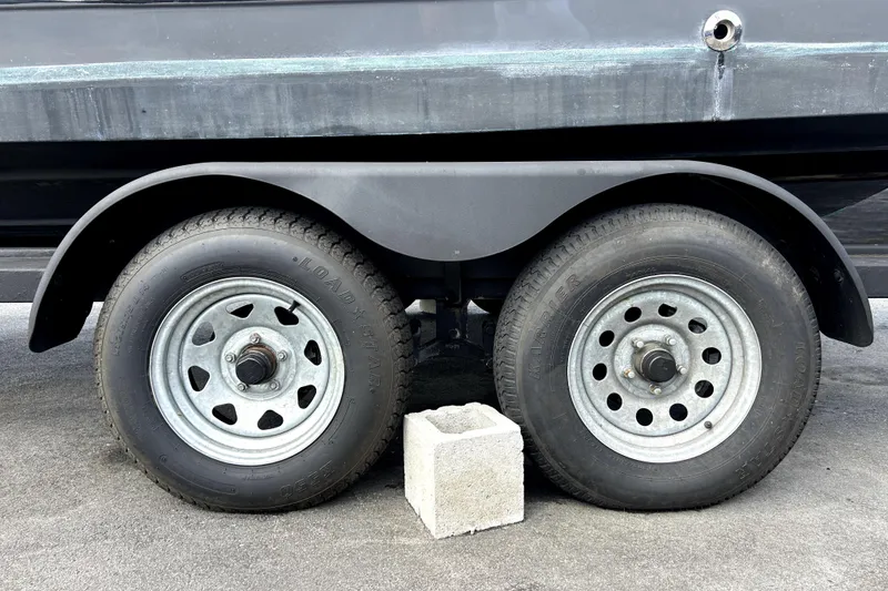 Slide: The Image of Trailer wheels of a 2020 Four Winns HD220 boat with a cinder block support. - 71