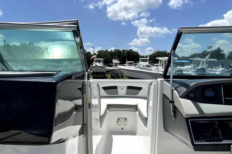 Slide: The Image of 2020 Four Winns HD220 boat interior with open cockpit and clear skies. - 27