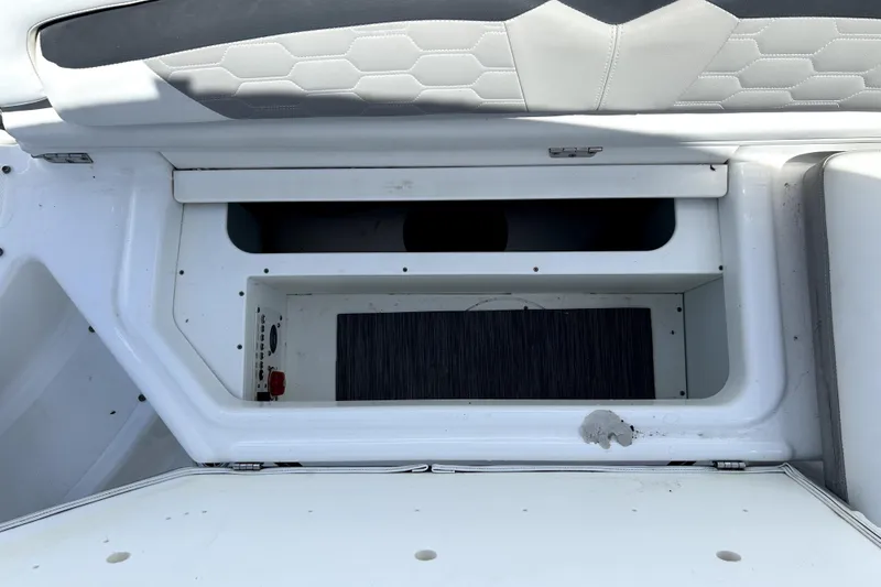 Slide: The Image of Storage compartment in a 2020 Four Winns HD220 boat, featuring a sleek design. - 48