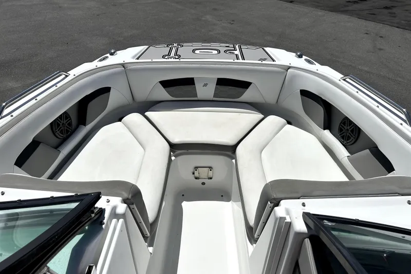 Slide: The Image of 2020 Four Winns HD220 boat interior with white seating and speakers. - 33