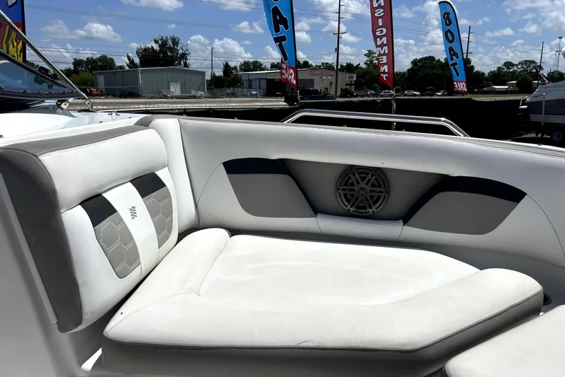 Slide: The Image of 2020 Four Winns HD220 boat interior with white cushioned seating and speaker. - 37