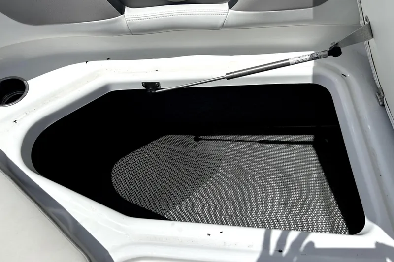 Slide: The Image of Storage compartment of a 2020 Four Winns HD220 boat, open with hydraulic support. - 42