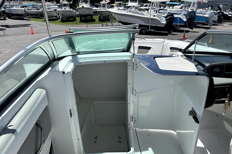 Slide: The Image of 2020 Four Winns HD220 boat interior with open storage compartment. - 32