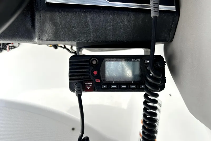 Slide: The Image of VHF radio on 2020 Four Winns HD220 boat dashboard. - 25