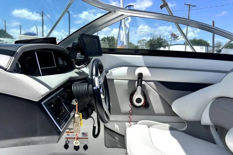 Slide: The Image of Interior of 2020 Four Winns HD220 boat with steering wheel and dashboard controls. - 26