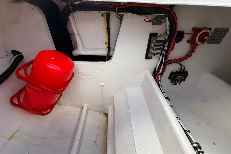 Slide: The Image of Interior of a 2020 HellKats 30 boat showing wiring and a red fire extinguisher. - 47