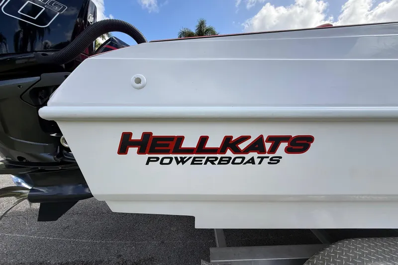 Slide: The Image of HellKats Powerboats logo on 2020 model 30, white hull, blue sky background. - 4