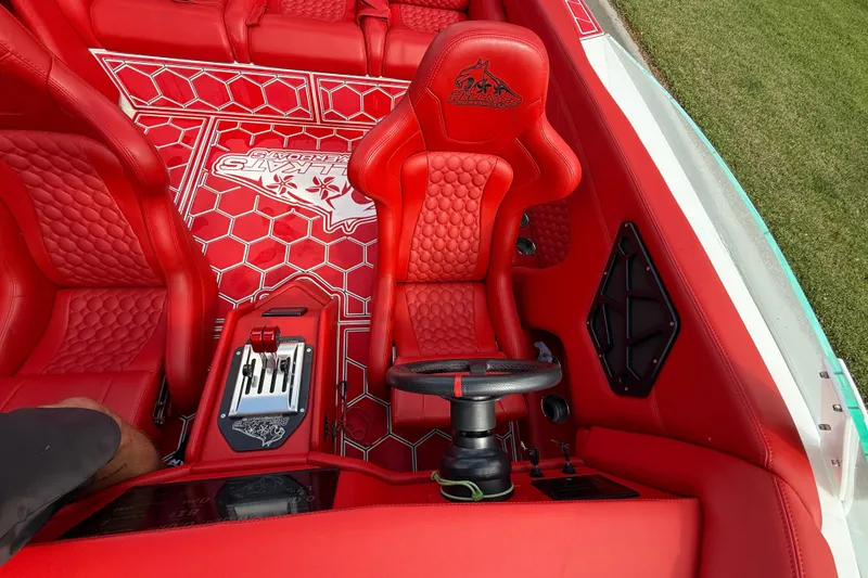Slide: The Image of Red interior of 2020 HellKats 30 boat with hexagonal pattern and steering wheel. - 39