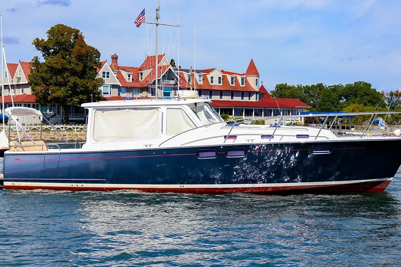 Slide: The Image of 2017 MJM 40z Downeast yacht cruising near a picturesque coastal town. - 43