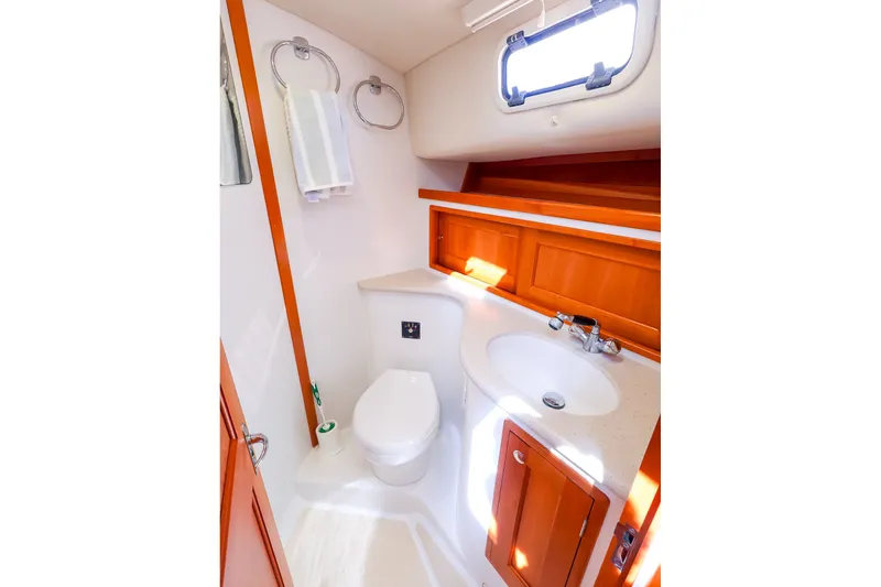 Slide: The Image of 2017 MJM 40z Downeast yacht bathroom with sink, toilet, and wooden cabinetry. - 38