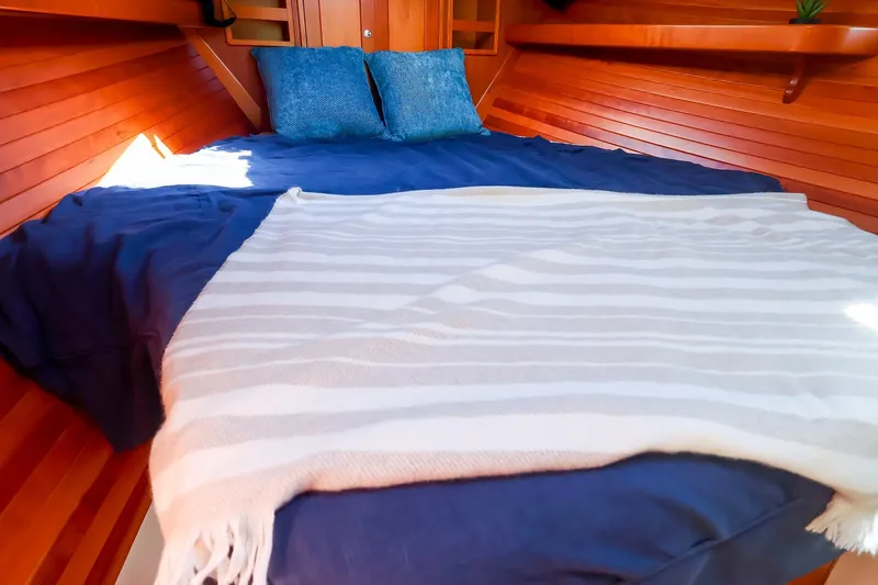 Slide: The Image of Cozy cabin interior of 2017 MJM 40z Downeast with wooden paneling and comfortable bedding. - 37