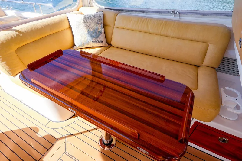 Slide: The Image of Luxurious interior of 2017 MJM 40z Downeast yacht with polished wood table and cushioned seating. - 18