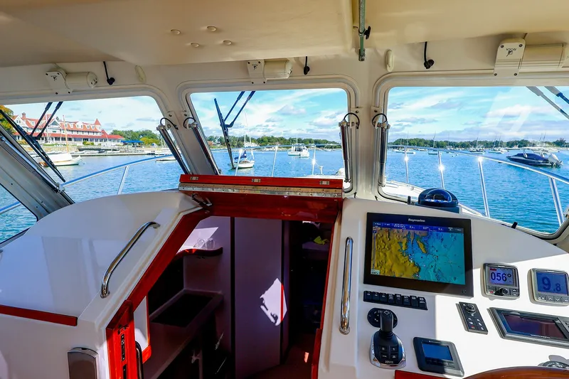 Slide: The Image of Interior view of 2017 MJM 40z Downeast yacht with navigation equipment and scenic harbor. - 23