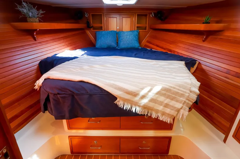 Slide: The Image of Cozy cabin interior of 2017 MJM 40z Downeast with wooden paneling and comfortable bedding. - 36
