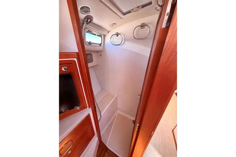 Slide: The Image of 2017 MJM 40z Downeast yacht interior with wooden cabinetry and porthole windows. - 39
