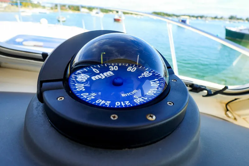 Slide: The Image of Compass on 2017 MJM 40z Downeast boat, with scenic water view in background. - 27