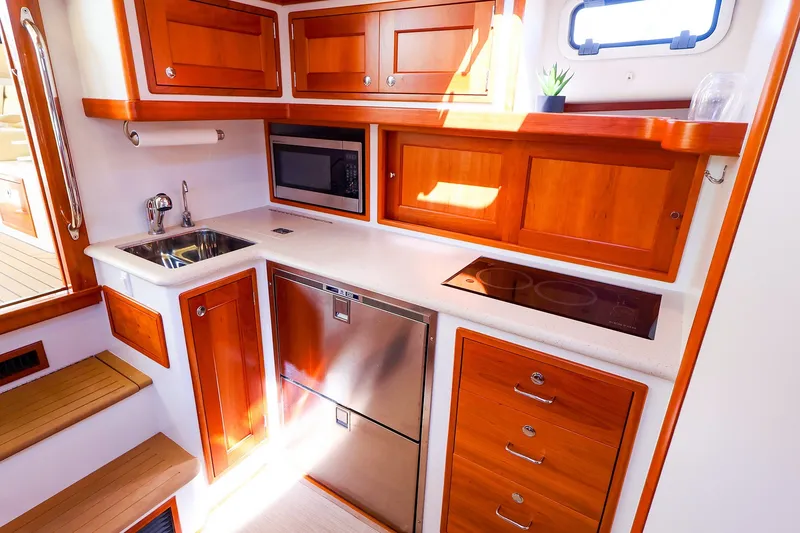 Slide: The Image of Luxurious 2017 MJM 40z Downeast yacht kitchen with wood cabinetry and modern appliances. - 32