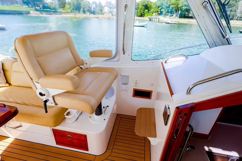 Slide: The Image of Luxurious interior of 2017 MJM 40z Downeast boat with tan seating and scenic water view. - 21