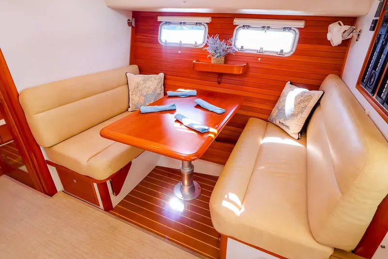 Slide: The Image of 2017 MJM 40z Downeast yacht interior with cozy dining area and elegant wood finish. - 31