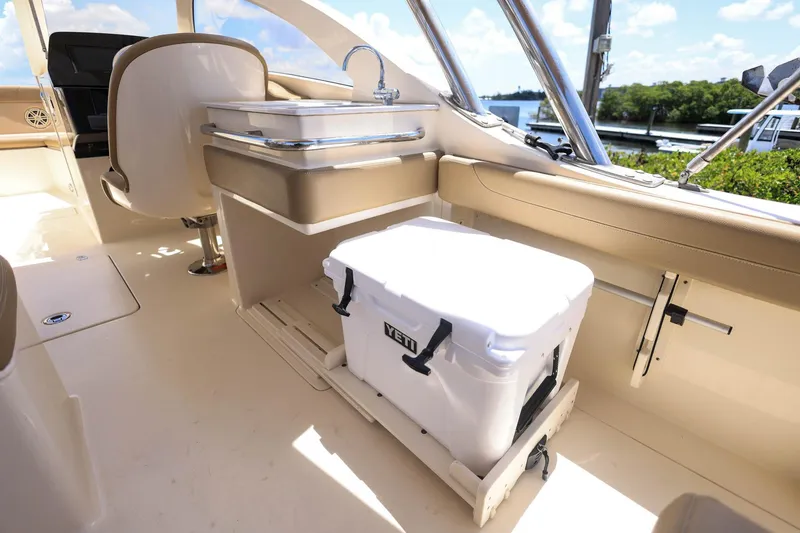 Slide: The Image of 2020 Scout 235 Dorado boat interior with Yeti cooler and seating area. - 12