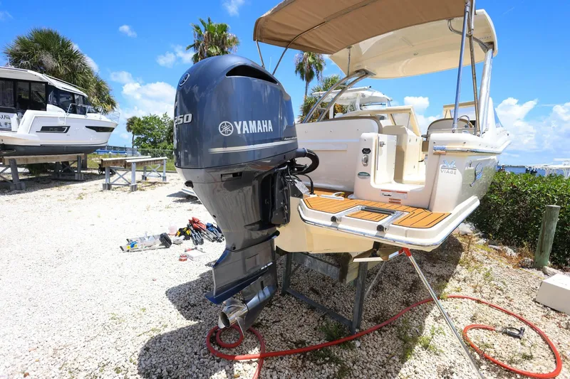 Slide: The Image of 2020 Scout 235 Dorado boat with Yamaha engine on display outdoors. - 2